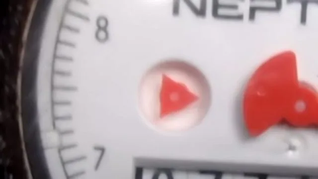 Close view of a water meter's dial and red indicator before a leak test